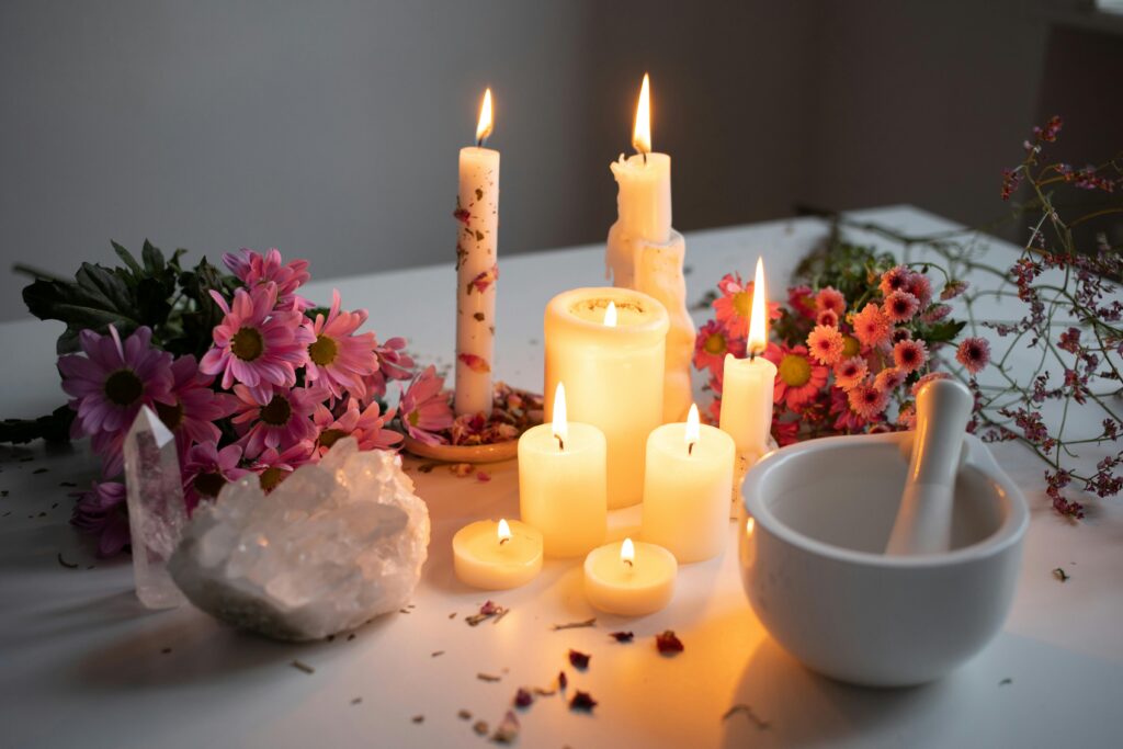 pexels-photo-20419179-20419179 Burning Candles by Pink Flowers on White Desk